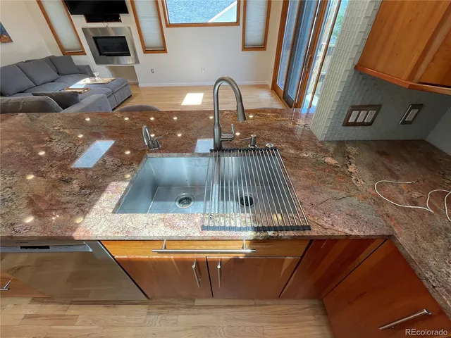 a large kitchen with stainless steel appliances granite countertop a large kitchen island and a sink