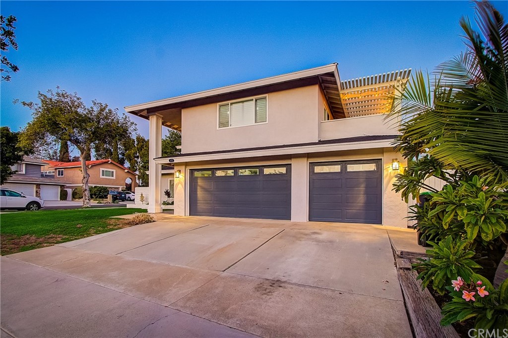 13772 Ridgecrest Circle Tustin, CA 92780 - Photo 2 of 69 a front view of a house with a yard and garage