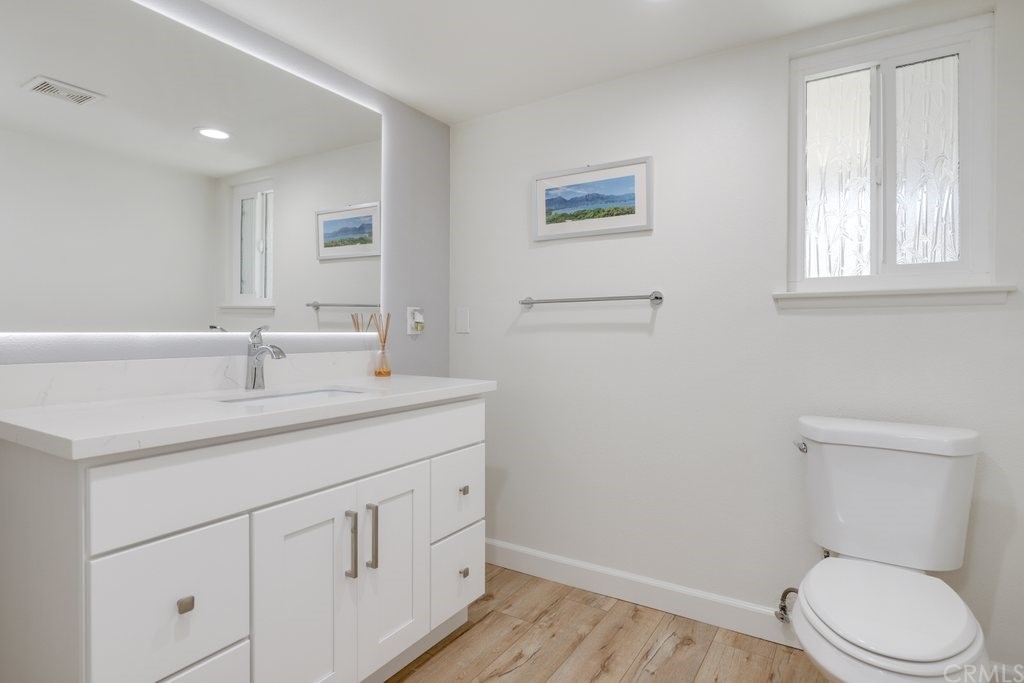 13772 Ridgecrest Circle Tustin, CA 92780 - Photo 14 of 69 a bathroom with a toilet a sink and mirror