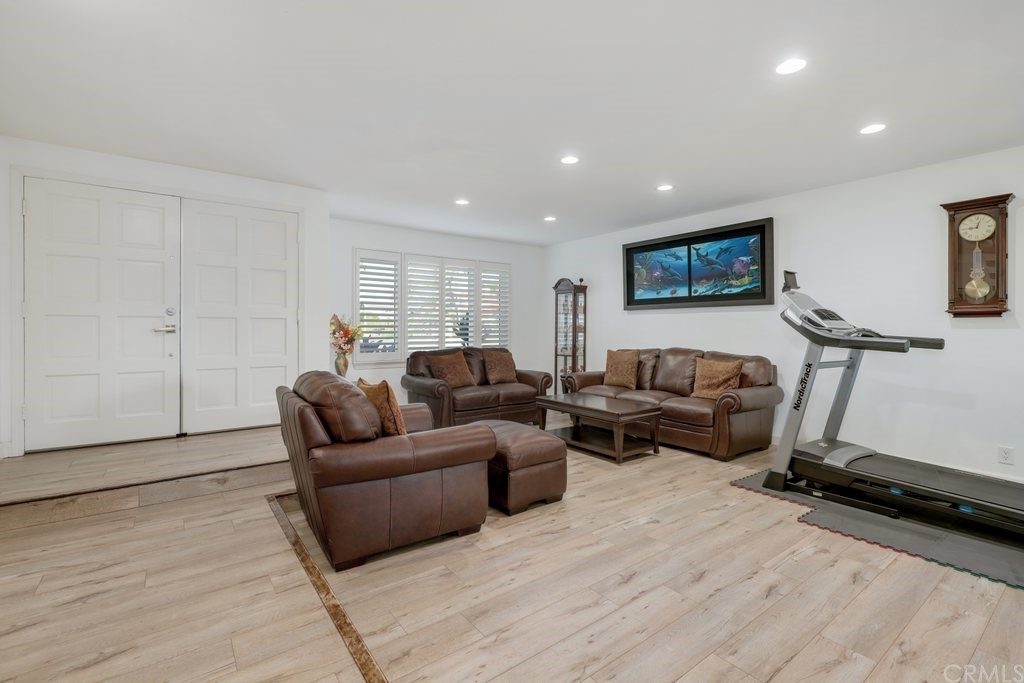 13772 Ridgecrest Circle Tustin, CA 92780 - Photo 16 of 69 a living room with furniture gym equipment and a flat screen tv