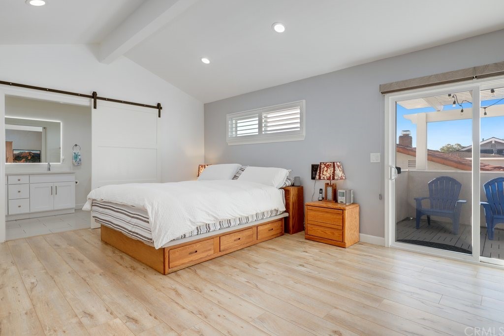 13772 Ridgecrest Circle Tustin, CA 92780 - Photo 27 of 69 a bedroom with a large bed and a chandelier