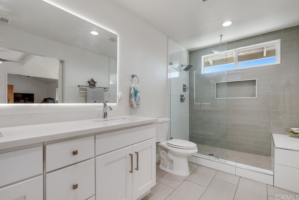 13772 Ridgecrest Circle Tustin, CA 92780 - Photo 34 of 69 a bathroom with a double vanity sink toilet and shower