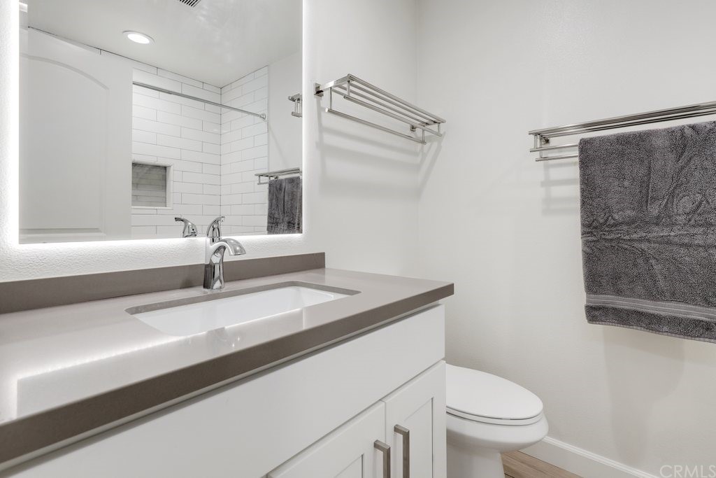 13772 Ridgecrest Circle Tustin, CA 92780 - Photo 41 of 69 a bathroom with a granite countertop sink toilet and shower