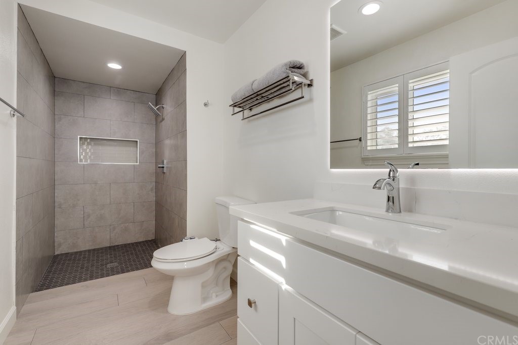 13772 Ridgecrest Circle Tustin, CA 92780 - Photo 44 of 69 a bathroom with a sink a toilet and a shower