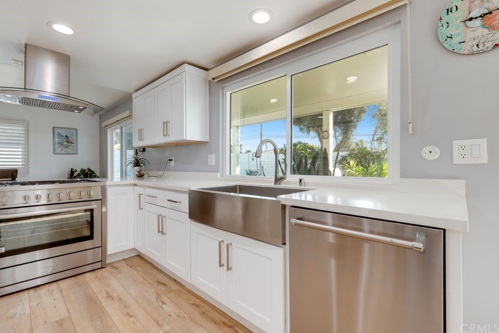 13772 Ridgecrest Circle Tustin, CA 92780 - Photo 7 of 69 a kitchen with white cabinets and appliances