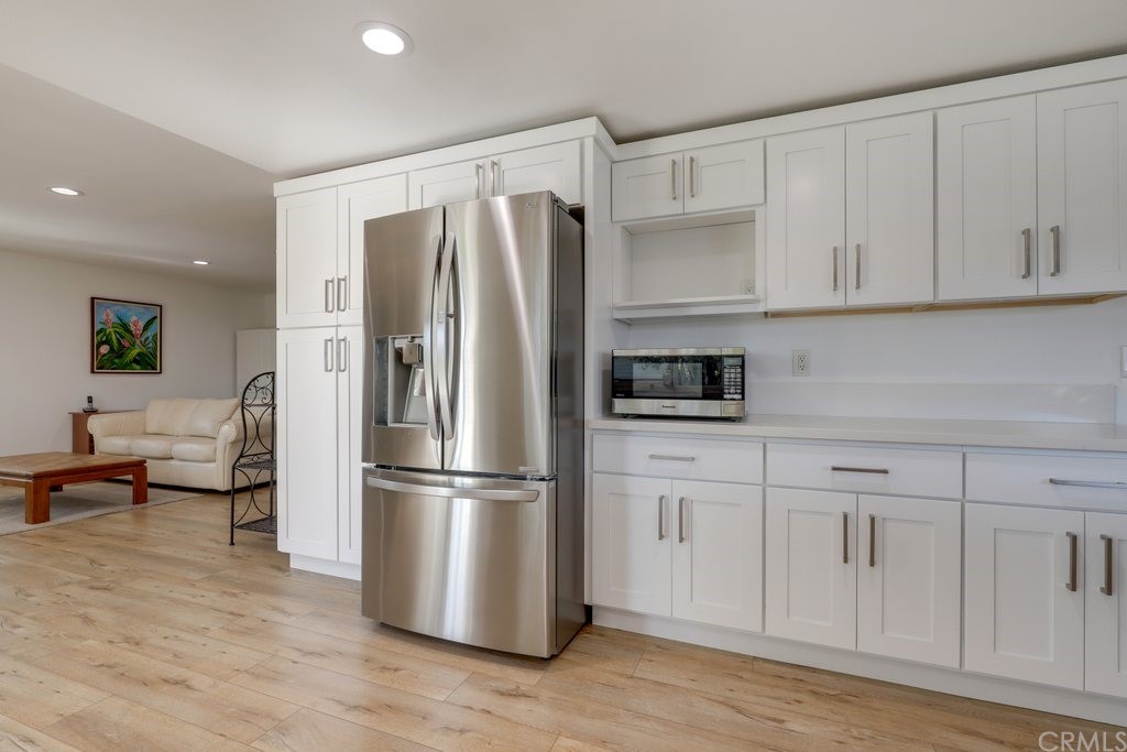 13772 Ridgecrest Circle Tustin, CA 92780 - Photo 9 of 69 a kitchen with stainless steel appliances a refrigerator and cabinets
