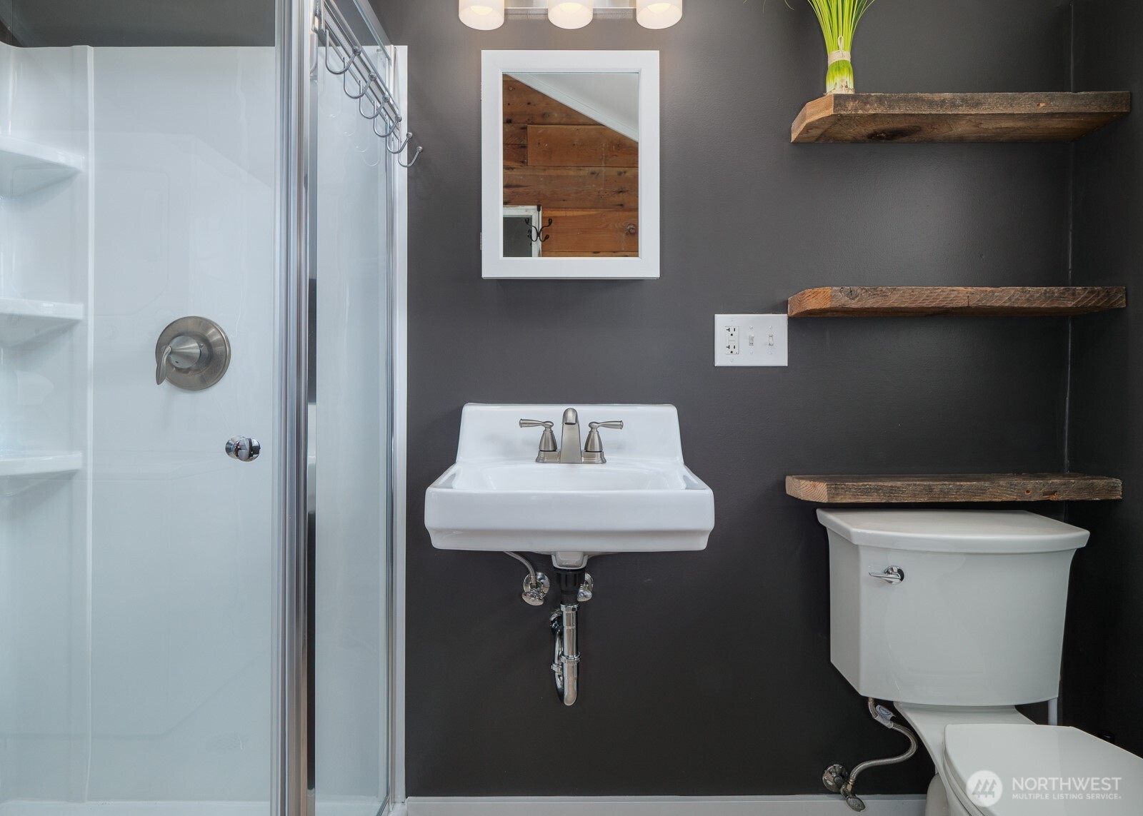233 West Washington Street Sequim, WA 98382 - Photo 10 of 40 a bathroom with a sink a toilet and mirror