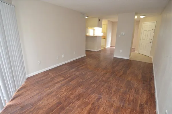a view of an empty room and wooden floor