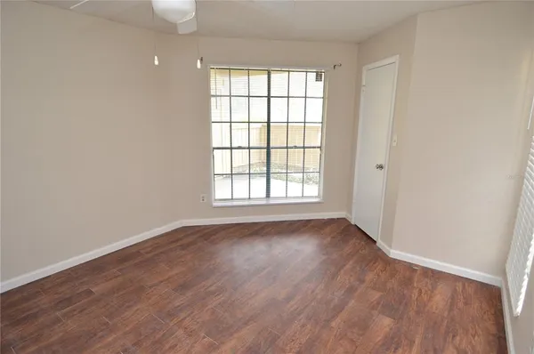 a view of a patio with table and chairs potted plants and large tree
