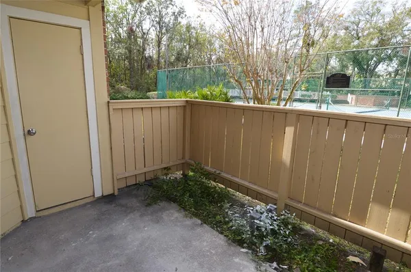a view of a room with wooden floor and outdoor space