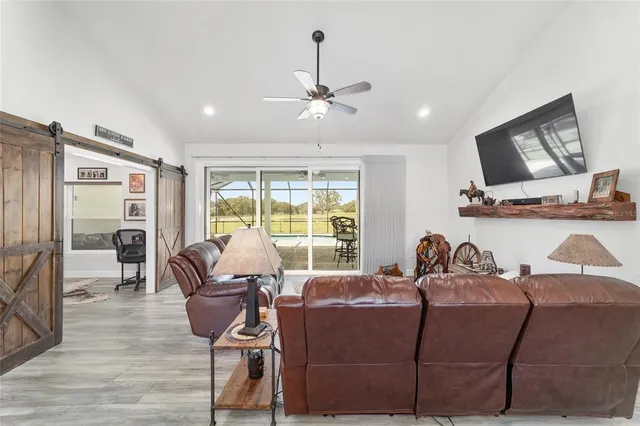 a kitchen with refrigerator and wooden floor