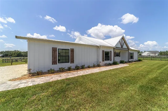 a living room with furniture a flat screen tv and wooden floor