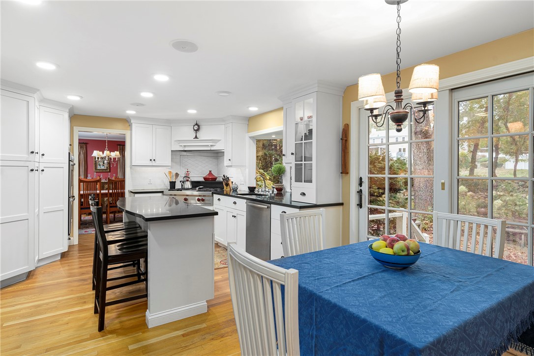 99 Larch Road East Greenwich, RI 02818 - Photo 13 of 38 Full view of kitchen with a peek out of the sliding doors to a perfect yard to entertain and enjoy family time.