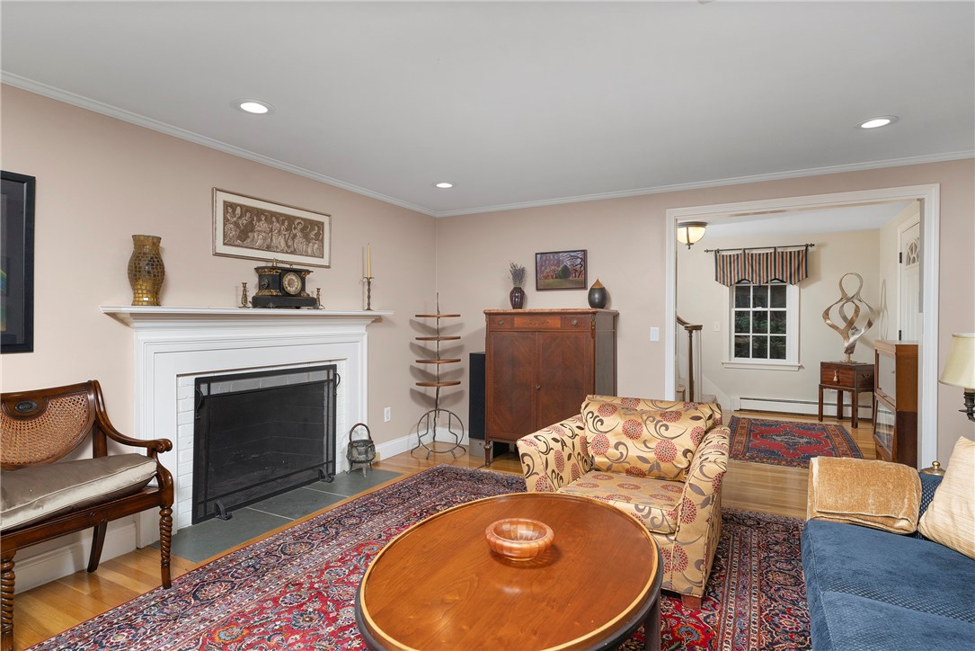99 Larch Road East Greenwich, RI 02818 - Photo 16 of 38 Another view of this beautiful living room. The custom wood mantle on the fireplace is the focal point