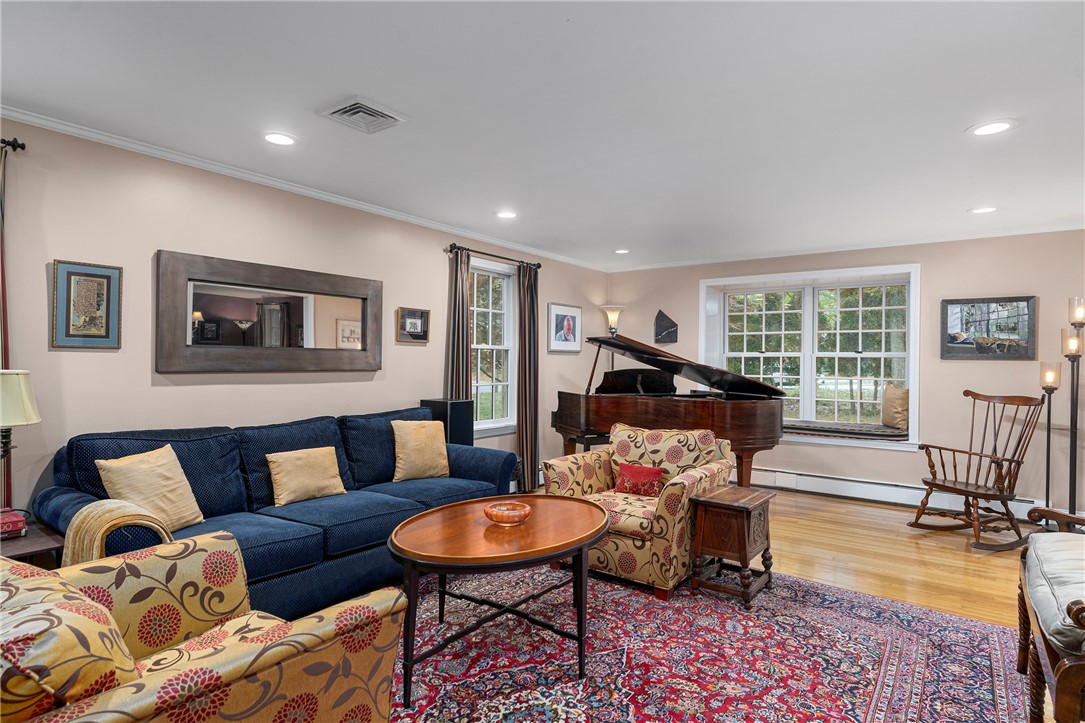 99 Larch Road East Greenwich, RI 02818 - Photo 18 of 38 View of formal living room from foyer. The double window & window seat invites you to sit and enjoy the view, read or listen to music, in a very special spot in this very special home.
