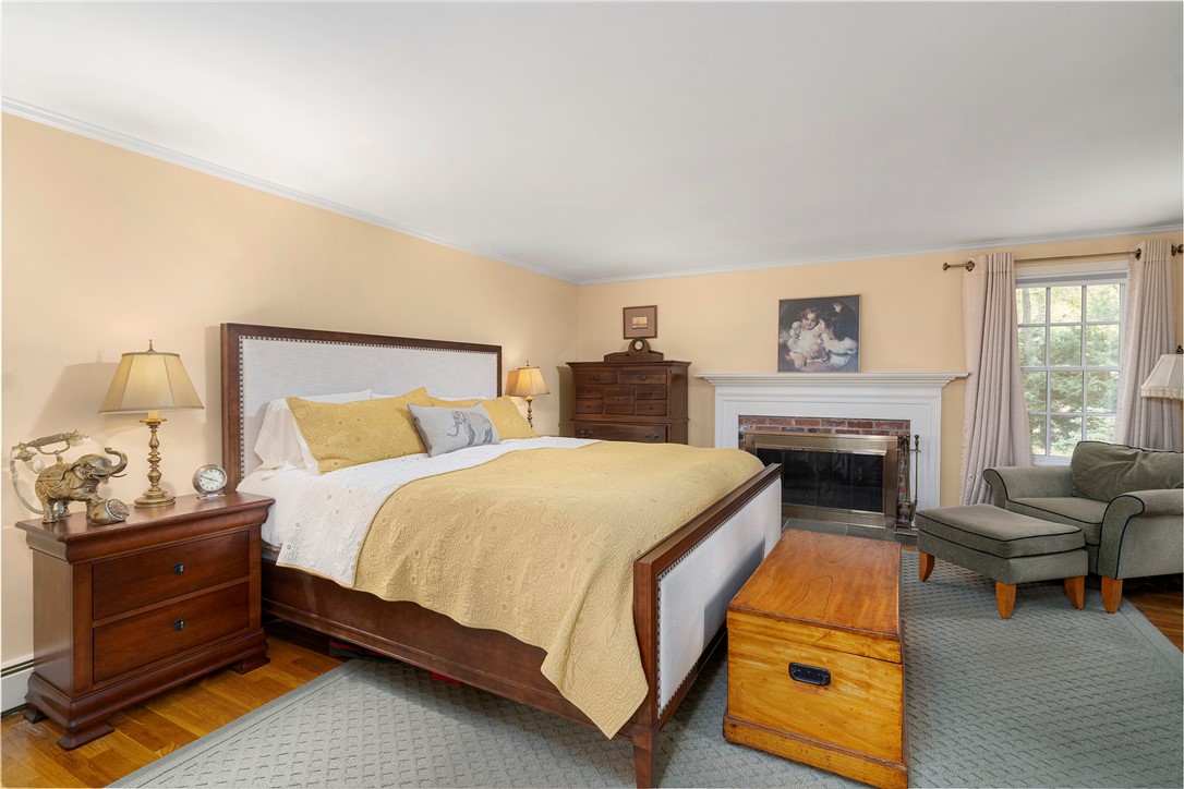 99 Larch Road East Greenwich, RI 02818 - Photo 19 of 38 A master suite most can only dream of. Red brick and custom wood mantle with blue stone hearth in your bedroom, so nice! and the closets in this suite will give you reason to shop more.