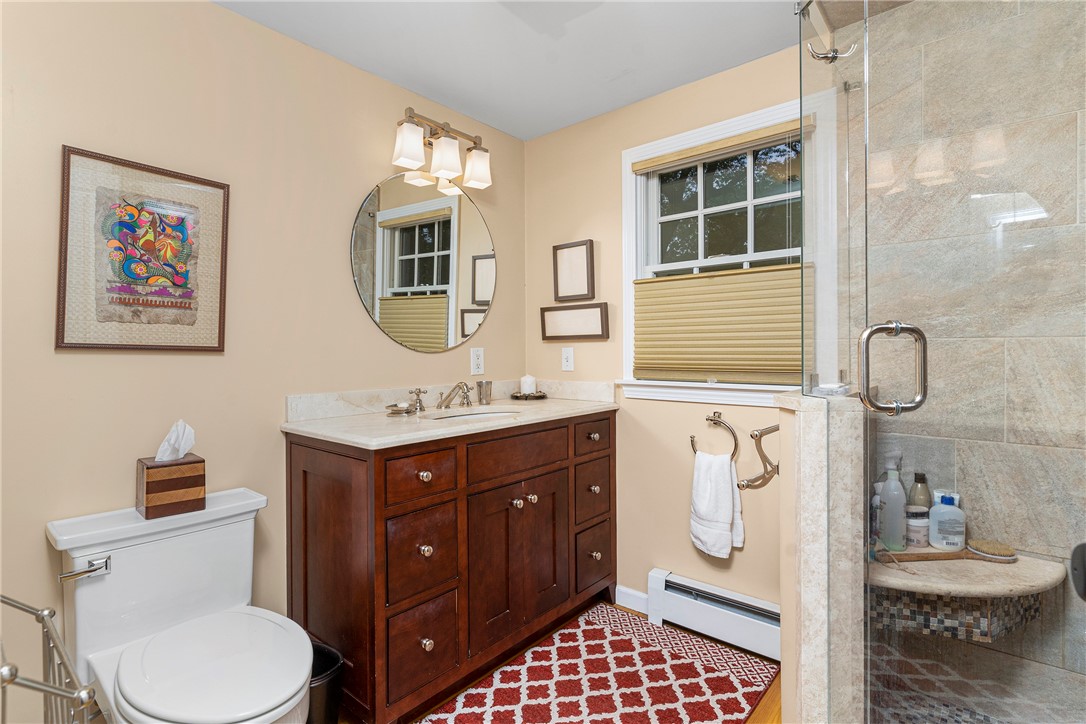 99 Larch Road East Greenwich, RI 02818 - Photo 21 of 38 Master bathroom with frameless shower and beautifully tiled.