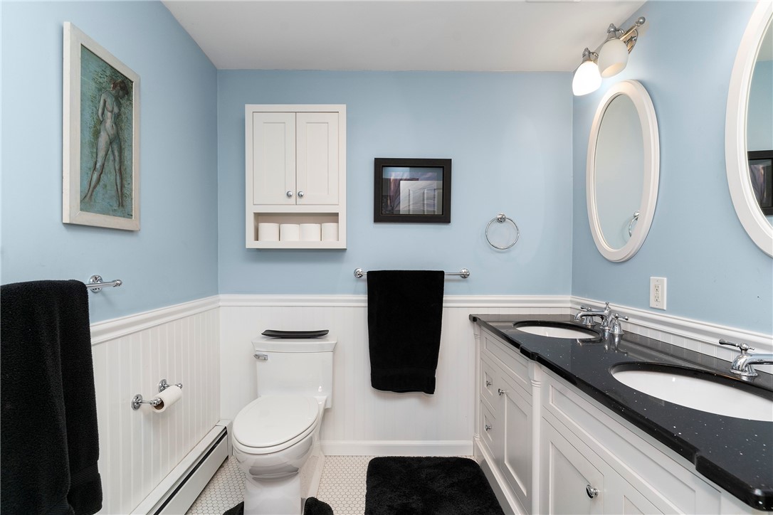 99 Larch Road East Greenwich, RI 02818 - Photo 26 of 38 WOW! family bathroom. 2 sink vanity, wainscoting, honeycomb tile and granite countertop, so beautiful!
