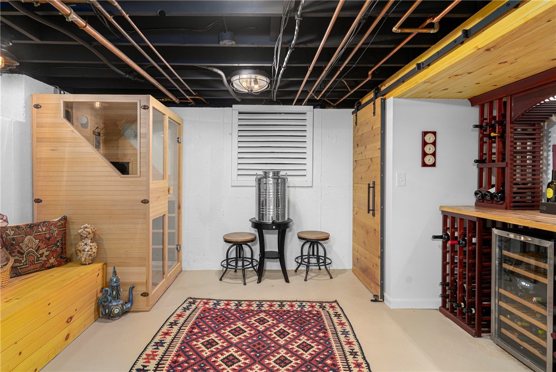 99 Larch Road East Greenwich, RI 02818 - Photo 30 of 38 Custom made wine room in lower level. Adults need a playroom too! Barn doors make a gorgeous look to extra closet space.