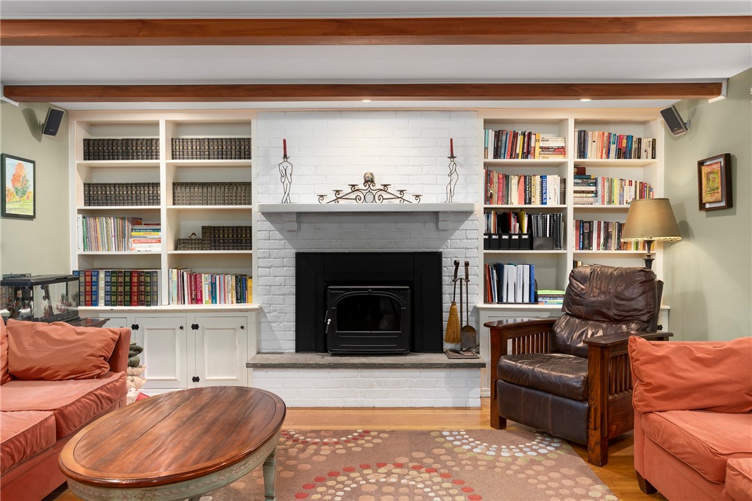 99 Larch Road East Greenwich, RI 02818 - Photo 7 of 38 2nd view of the family room. The custom built in book cases and cabinets flank the white painted brick fireplace. Cozy family evenings will be enjoyed every night in this wonderful room