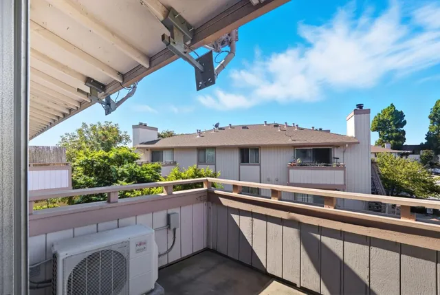 a view of balcony with outdoor seating and wooden floor