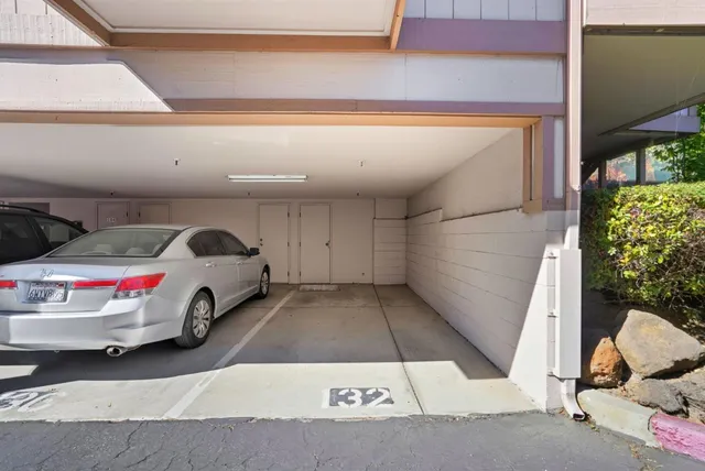a view of a house with backyard and a tree