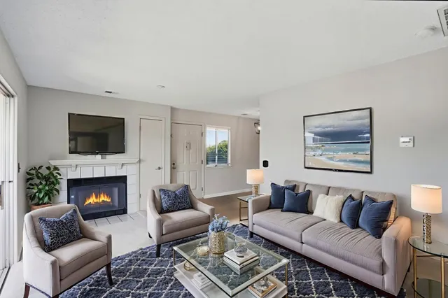 a living room with furniture and a fireplace