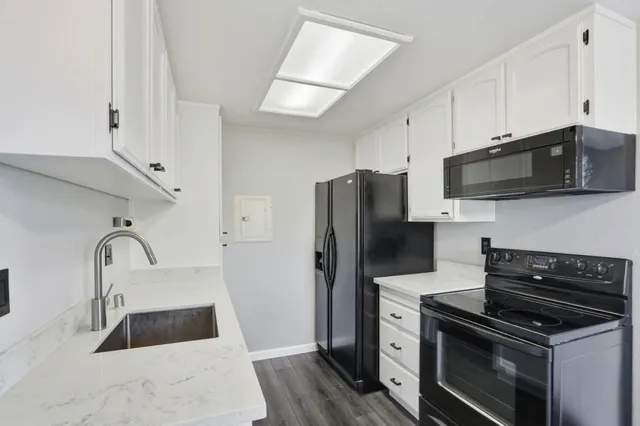 a kitchen with a refrigerator stove and microwave
