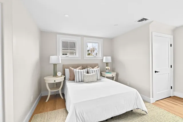 a bedroom with a bed and a night stand