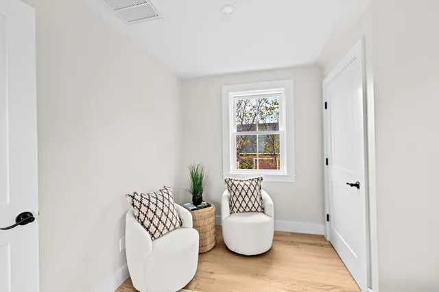 a view of living room with furniture and wooden floor