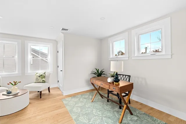 a workspace room with furniture and wooden floor