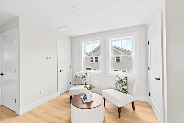 a living room with furniture a rug and a window