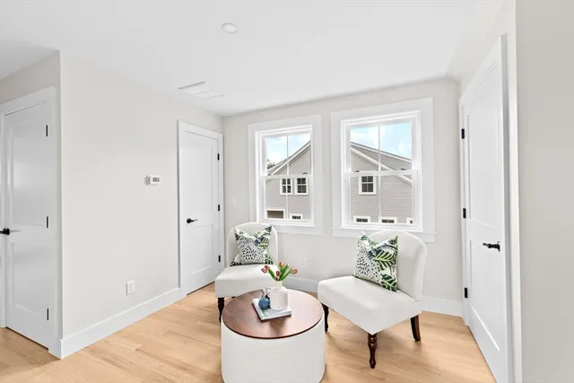 a living room with furniture a rug and a window