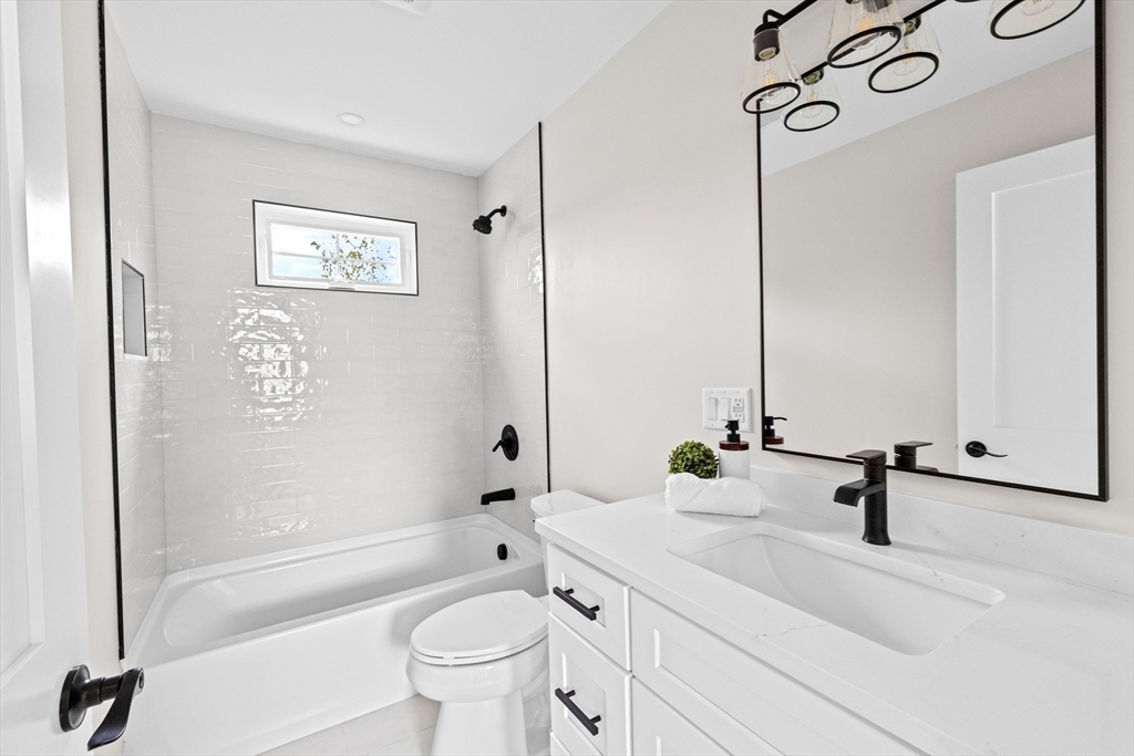 19 Ford Place, Unit 3 Scituate, MA 02066 - Photo 32 of 41 a bathroom with a sink a toilet and a mirror