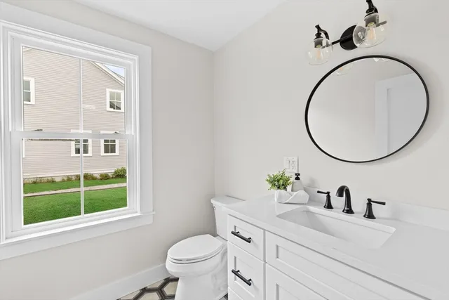 a bathroom with a sink a toilet and a mirror