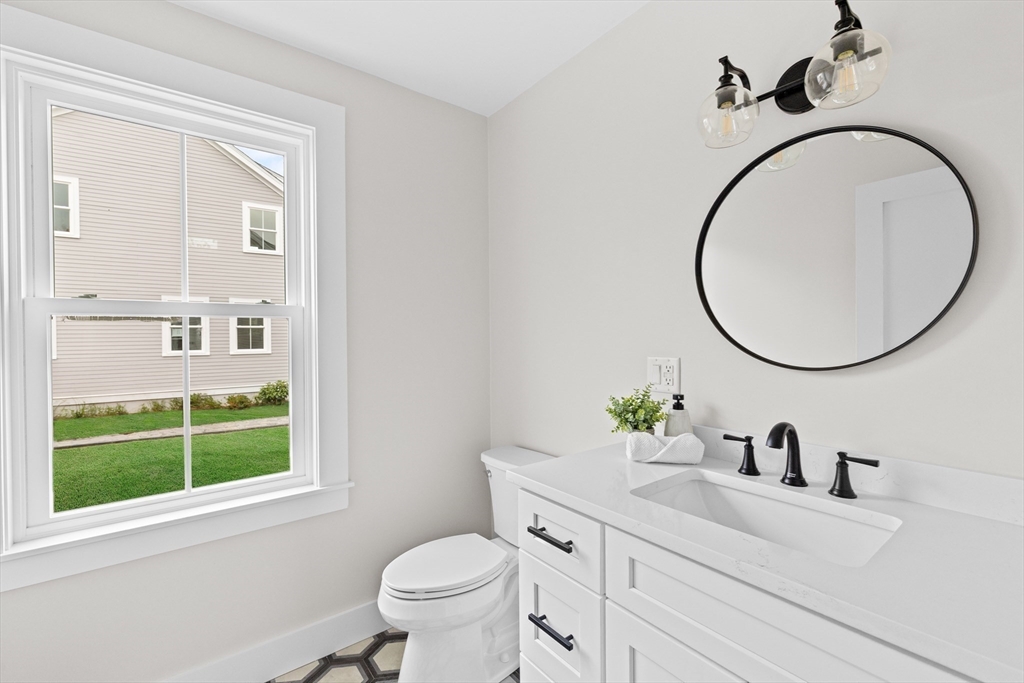 19 Ford Place, Unit 3 Scituate, MA 02066 - Photo 33 of 41 a bathroom with a sink a toilet and a mirror