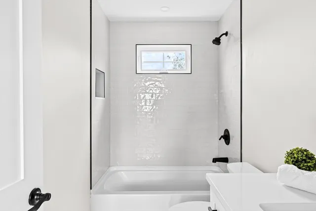 a bathroom with a bathtub and shower