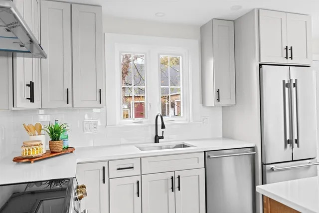 a kitchen with stainless steel appliances a refrigerator sink and stove