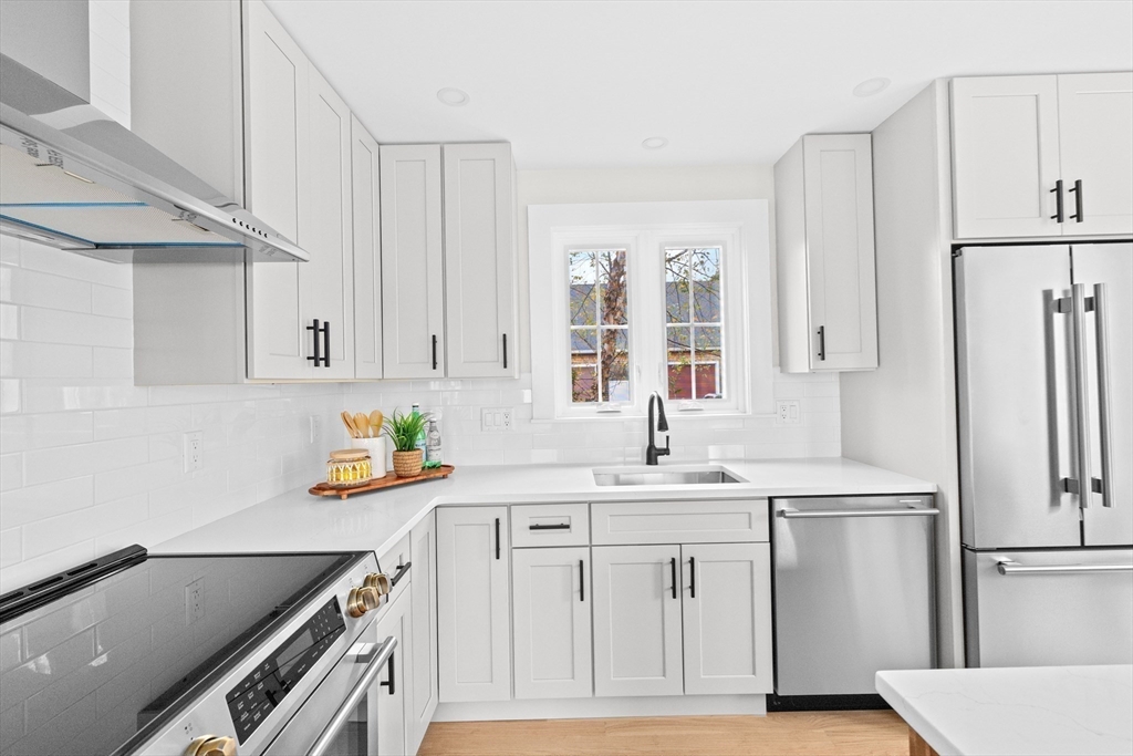19 Ford Place, Unit 3 Scituate, MA 02066 - Photo 5 of 41 a kitchen with white cabinets and white appliances