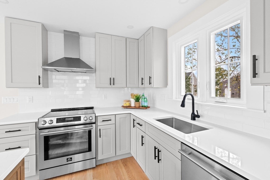 19 Ford Place, Unit 3 Scituate, MA 02066 - Photo 6 of 41 a kitchen with granite countertop a sink stainless steel appliances and cabinets