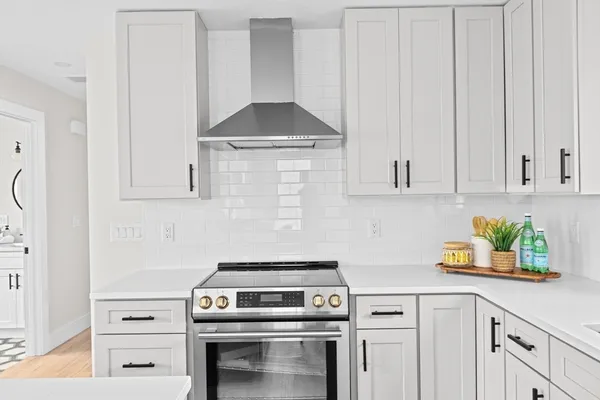 a kitchen with a stove and cabinets