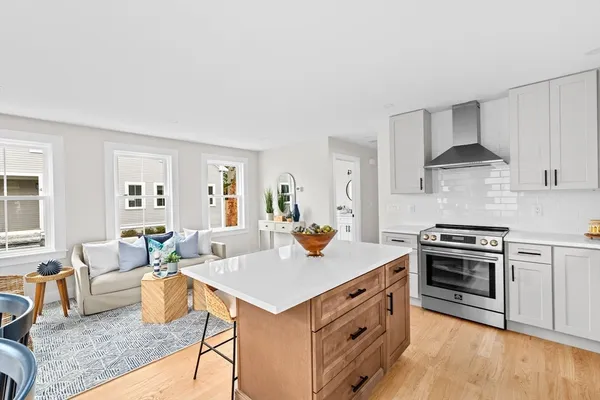 a view of kitchen with sink stove and refrigerator