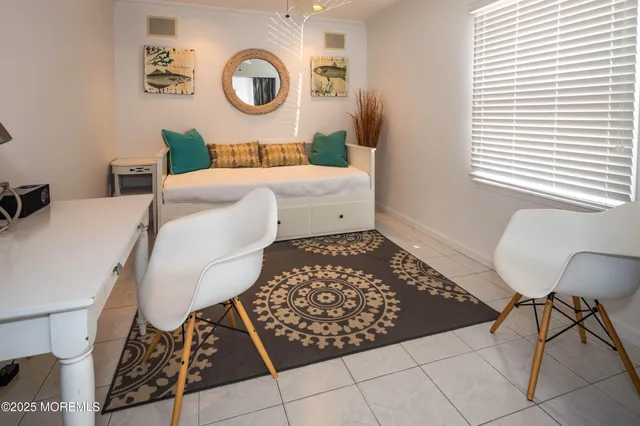 a bedroom with a bed and a lamp next to a window