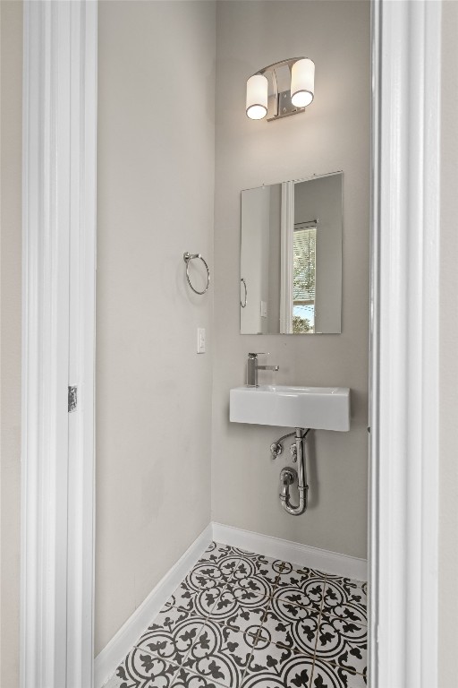 5610 Patrick Street, Unit L Houston, TX 77076 - Photo 16 of 28 a bathroom with a sink a light fixture and a toilet