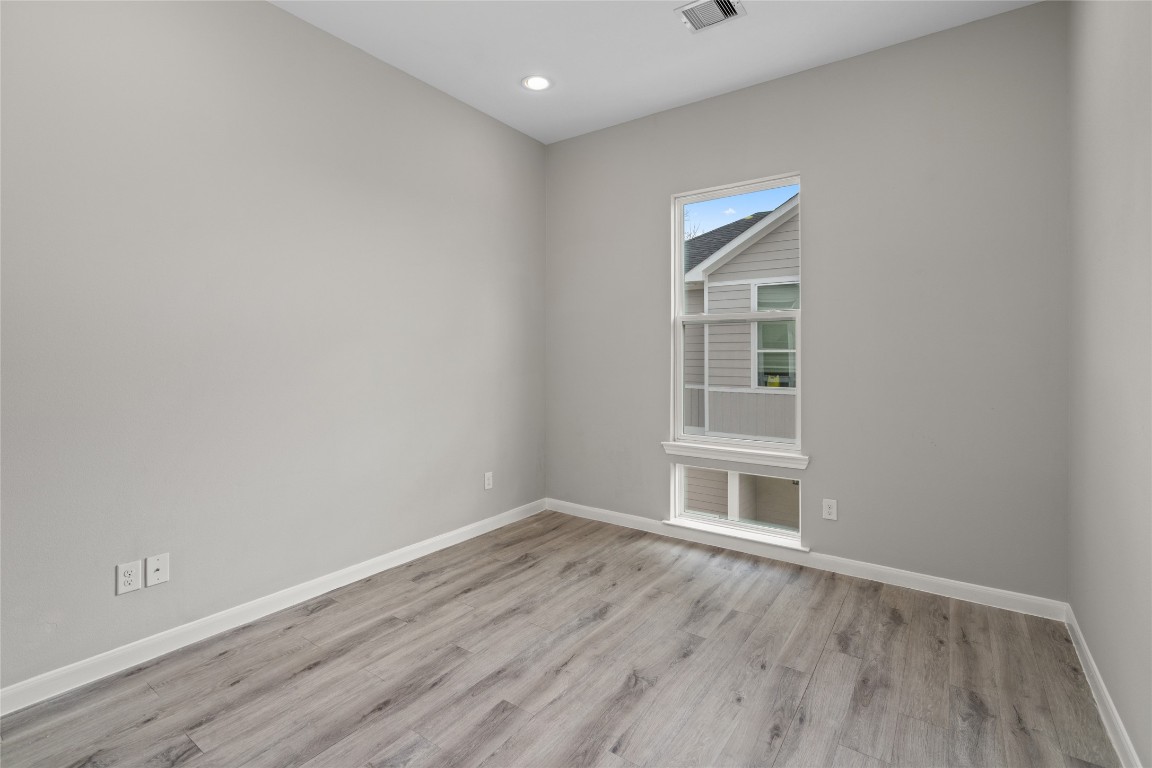 5610 Patrick Street, Unit L Houston, TX 77076 - Photo 25 of 28 a view of empty room with wooden floor and fan