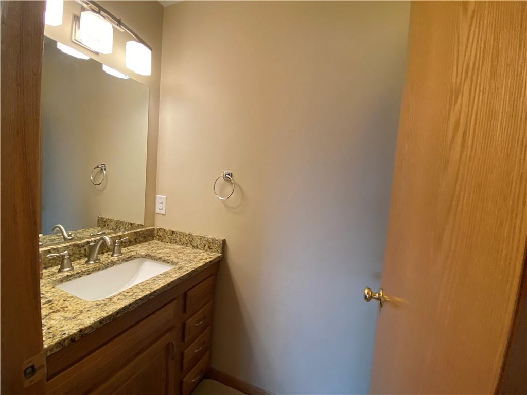 725 Rollinson Road Hermitage, PA 16148 - Photo 10 of 26 a bathroom with a granite countertop sink and a mirror
