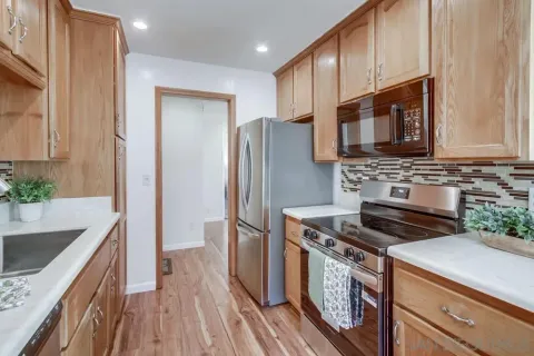 a kitchen with a stove a microwave and a sink