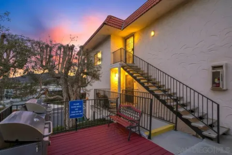 a view of a house with wooden deck