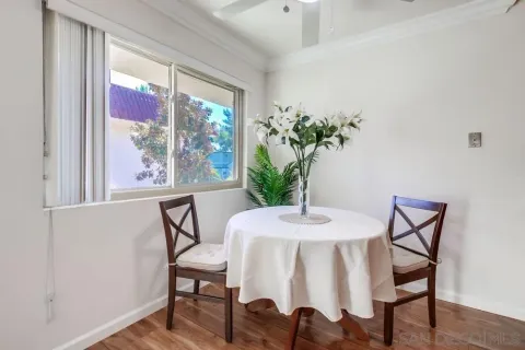 a view of a dining room with furniture window and wooden floor