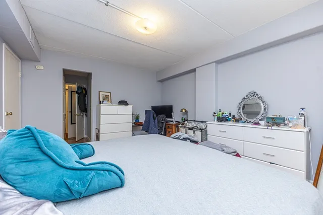 a living room with furniture cabinets and a window